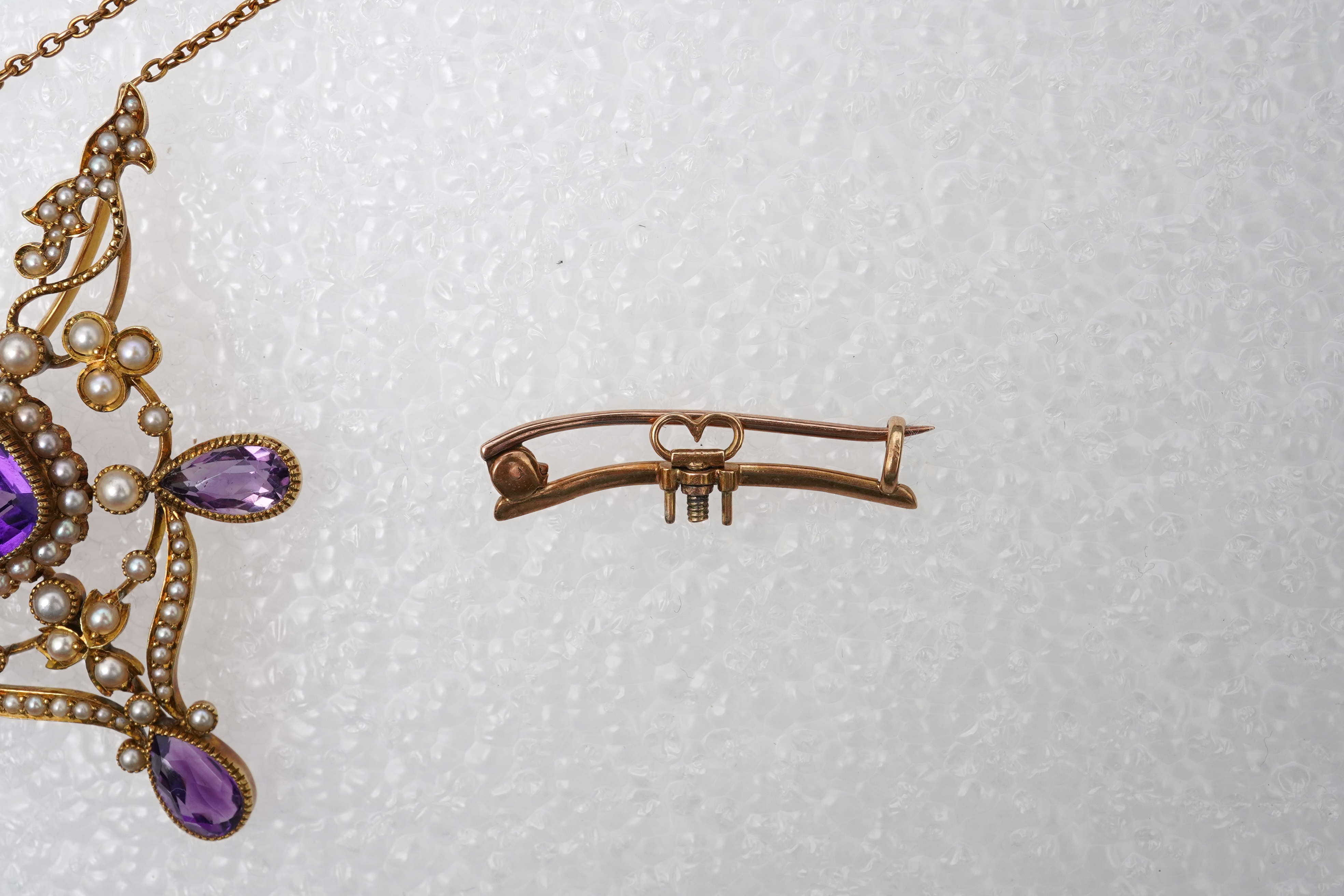 An Edwardian seed pearl and amethyst pendant/brooch, early 20th century